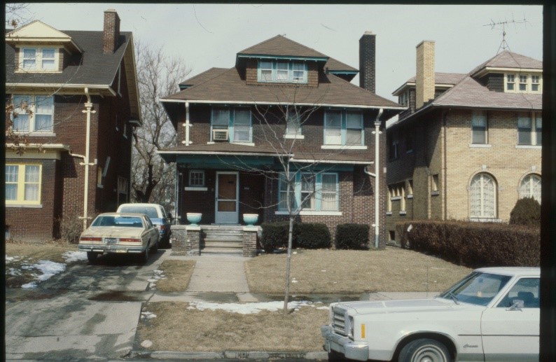 An older photo of a house with a brown brick gable